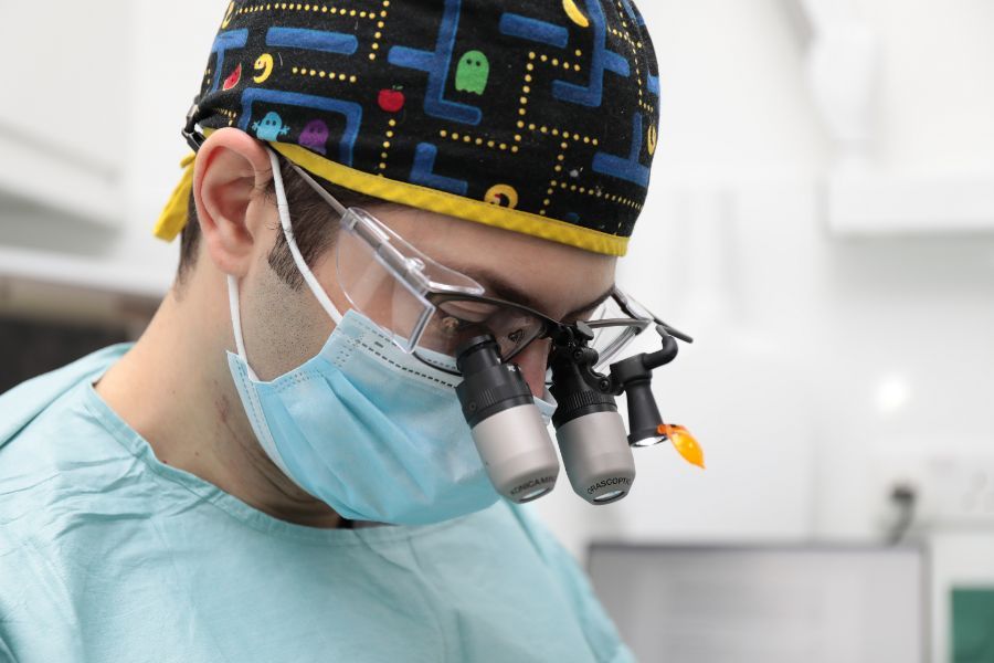 Dr Eric Battista placing a dental implant with surgical loupes