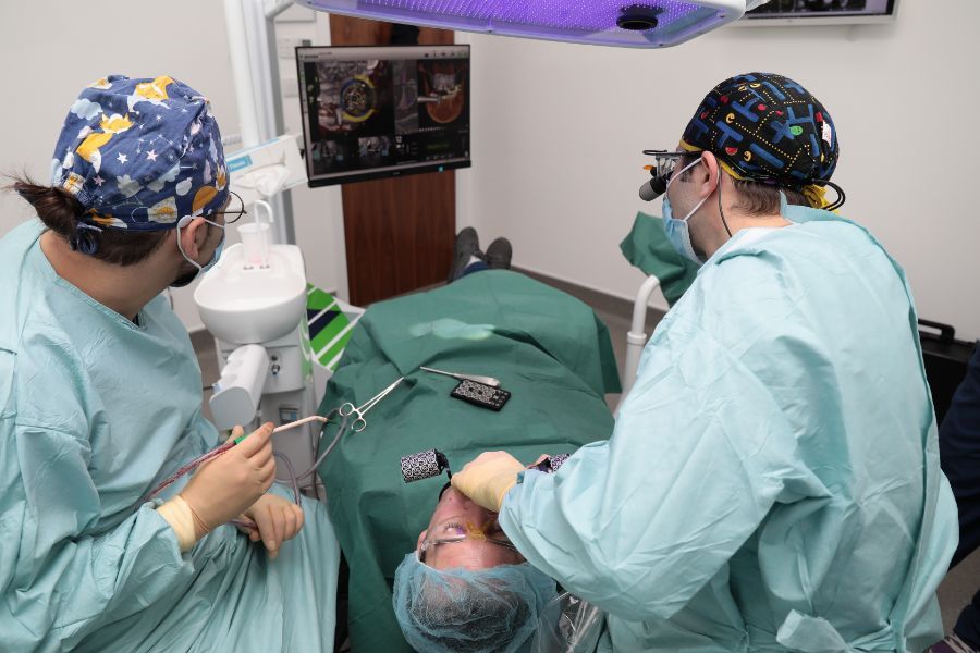 Dr Eric Battista operating with his surgical team